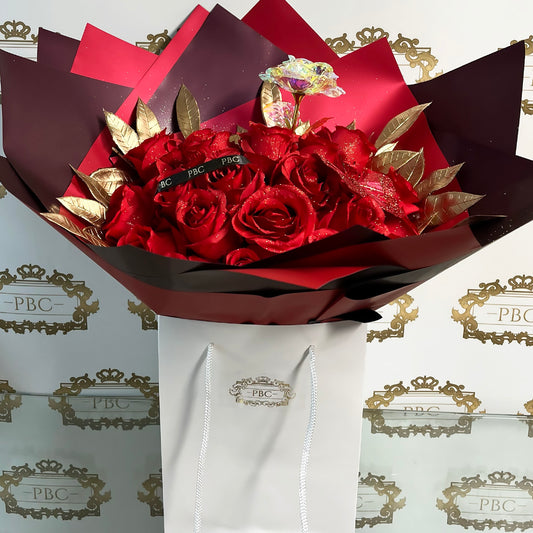 Flower bouquet filled with red roses and golden foliage
