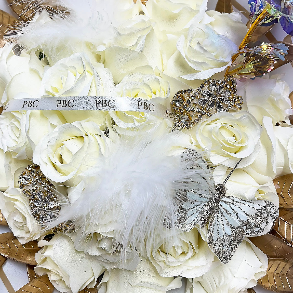 Decorative embellishment on PBC Gifts white flower bouquet